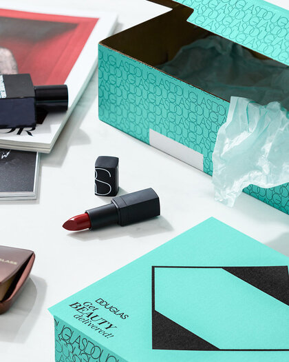 Opened mint DOUGLAS boxes and various products on a table