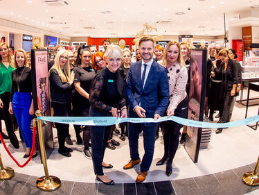 Multiple employees at a DOUGLAS store opening ceremony